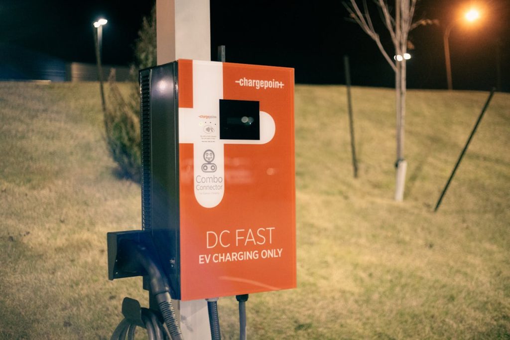 EV charging station illuminated at night on a roadside